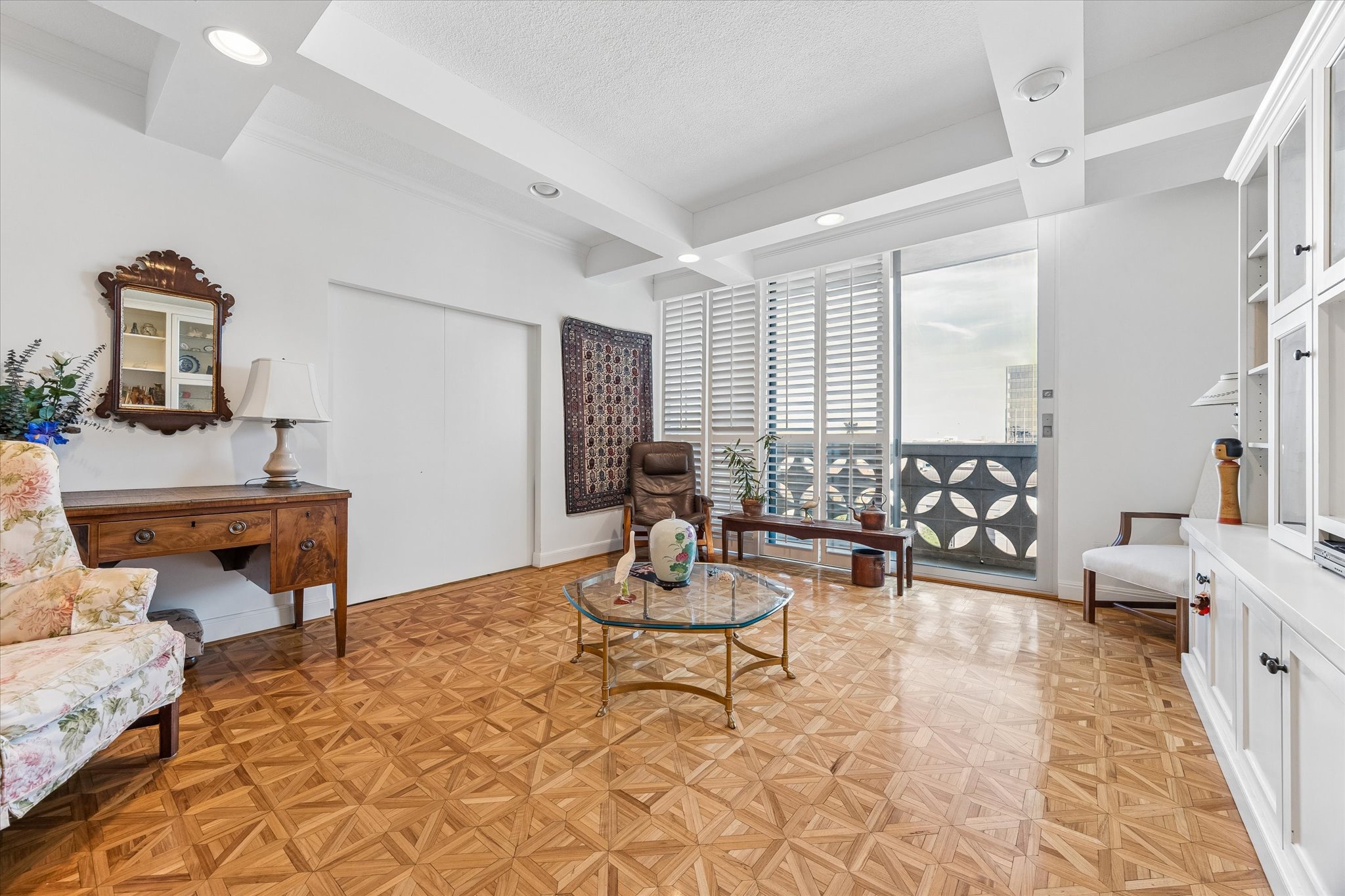 1801 Lavaca Street, Unit 6E Austin, TX 78701 - Photo 3 of 32 Sitting room featuring real parquet flooring, coffered ceiling, a textured ceiling, and recessed lighting