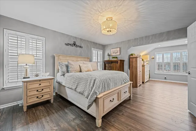 a spacious bedroom with a bed and a large window