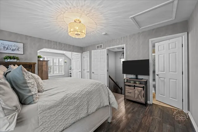 a bedroom with a bed and a television in it