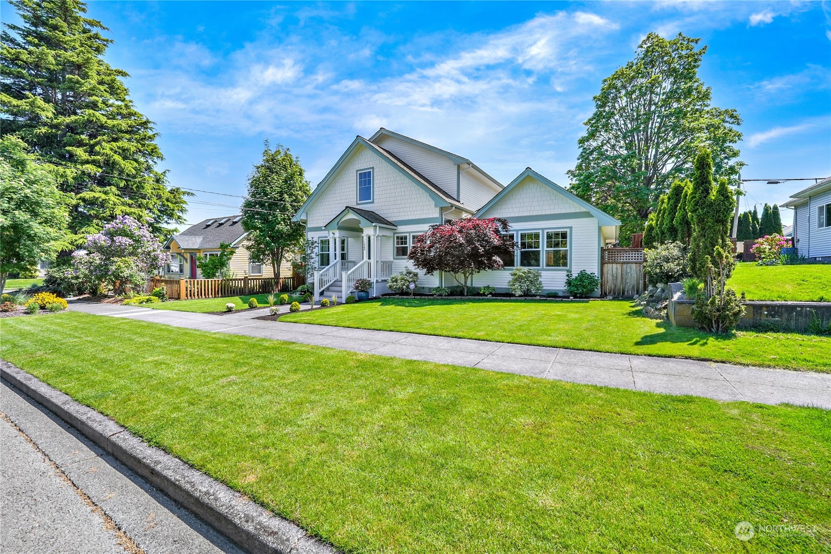 a front view of house with yard and green space