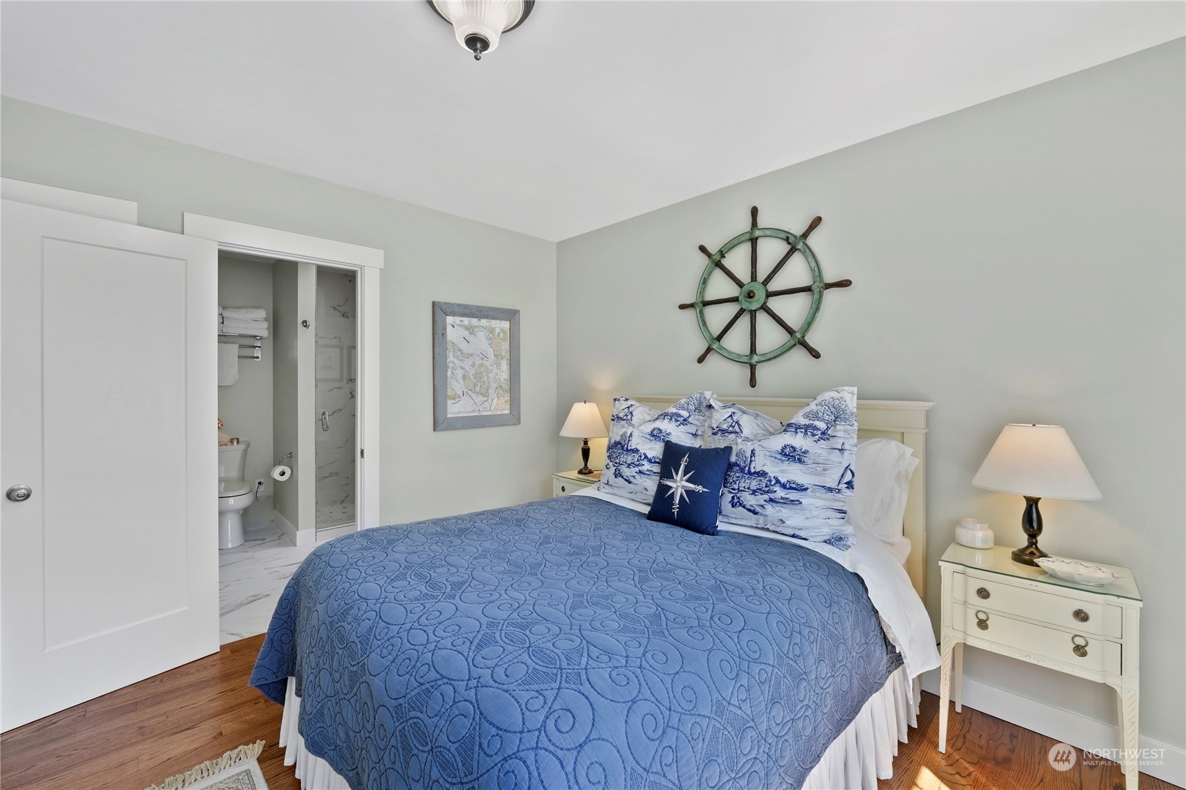 1505 9th Street Anacortes, WA 98221 - Photo 25 of 40 a bedroom with a bed and a chandelier