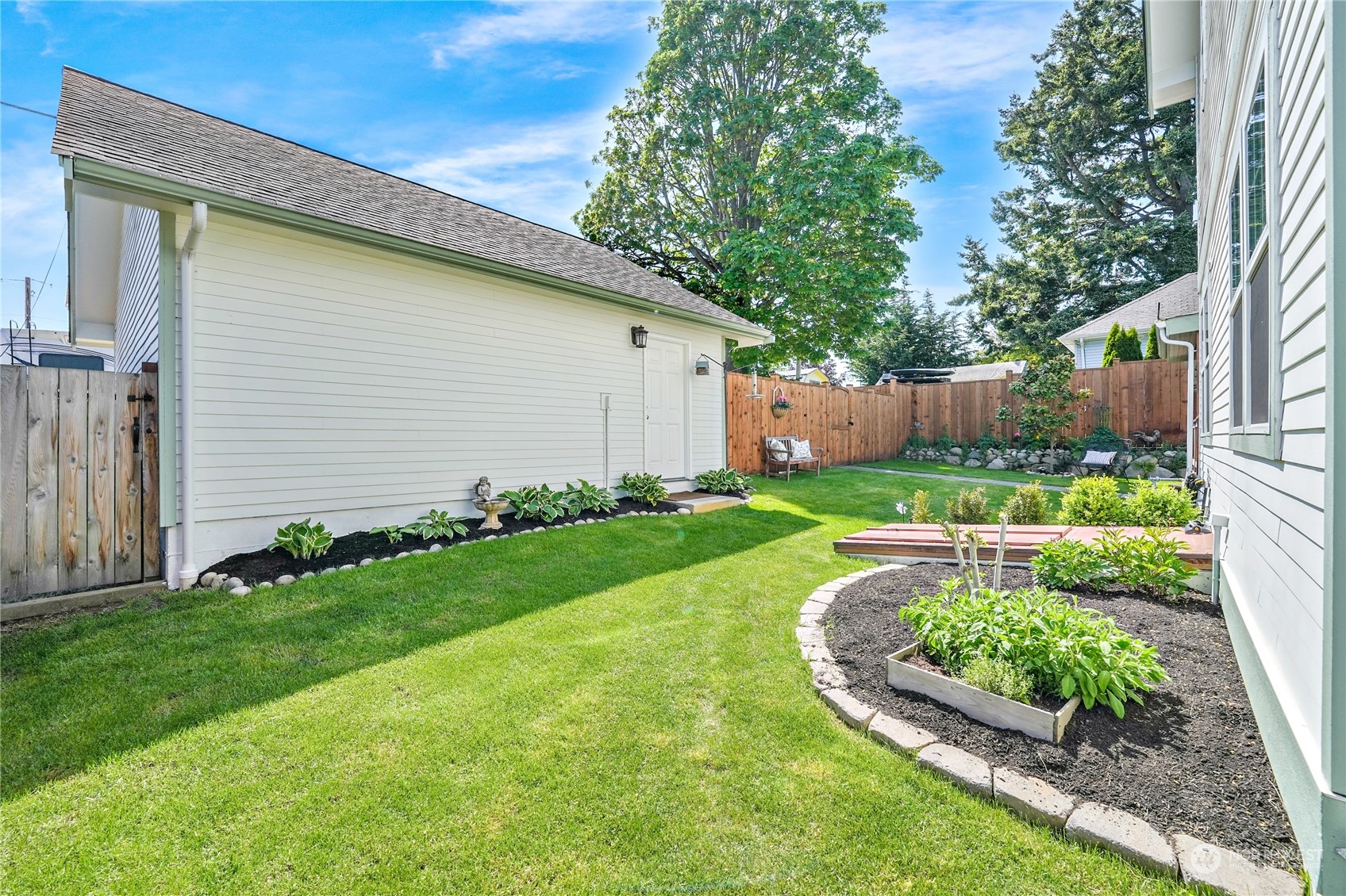 1505 9th Street Anacortes, WA 98221 - Photo 36 of 40 a view of a backyard with plants and a garden