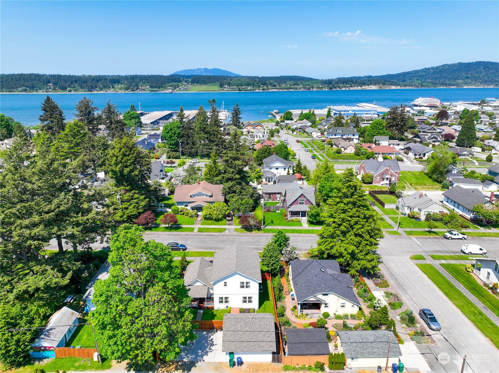 1505 9th Street Anacortes, WA 98221 - Photo 40 of 40 an aerial view of a city with lots of residential buildings ocean and mountain view in back