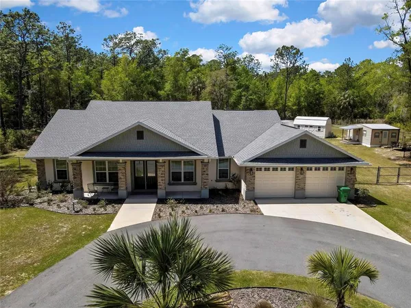 a view of a workspace with furniture and wooden floor
