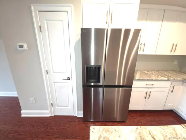 a view of kitchen with furniture and refrigerator