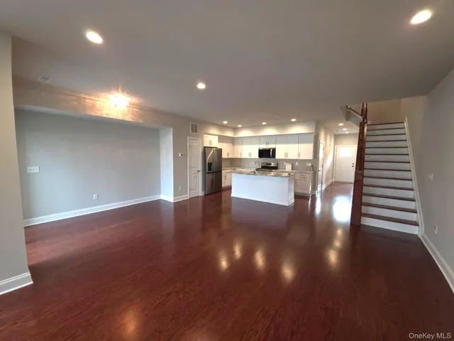 a view of a room with lots of wooden furniture
