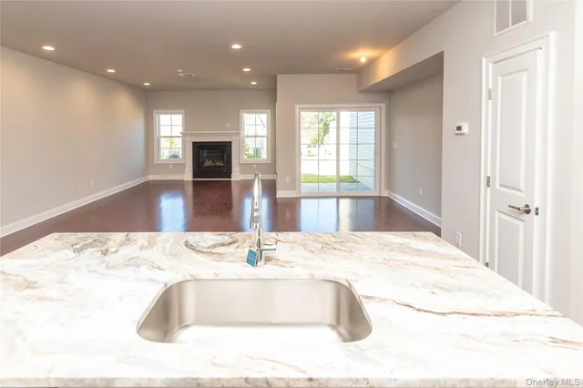 a view of kitchen with granite countertop sink and fireplace