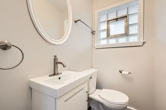 a white toilet sitting next to a bathroom sink