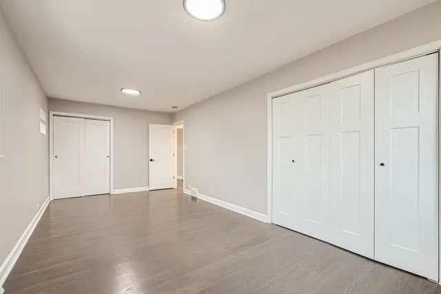 a view of an empty room and wooden floor