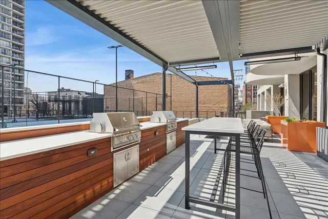 a view of a patio with table and chairs with wooden floor and fence