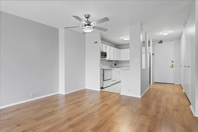 a view of a kitchen with wooden floor and a sink