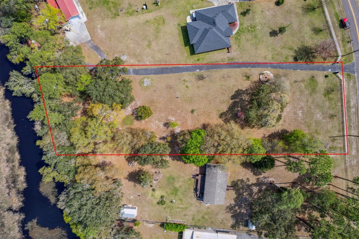 85166 Blackmon Road Yulee, FL 32097 - Photo 3 of 26 an aerial view of a house with a yard