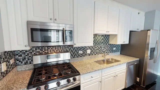 a kitchen with stainless steel appliances a refrigerator and a stove top oven