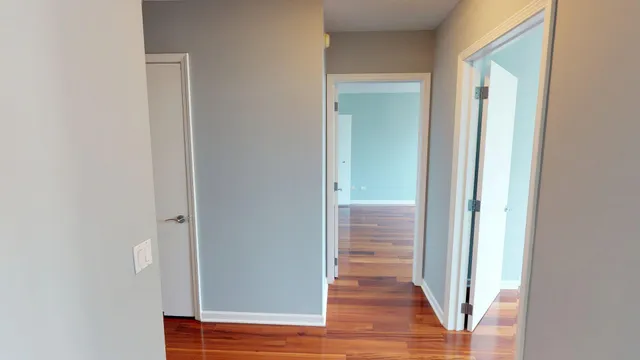 a view of a room with wooden floor and a window