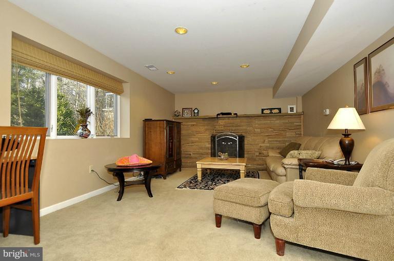 6312 Walhonding Road Bethesda, MD 20816 - Photo 25 of 29 Lower level rec room with fireplace