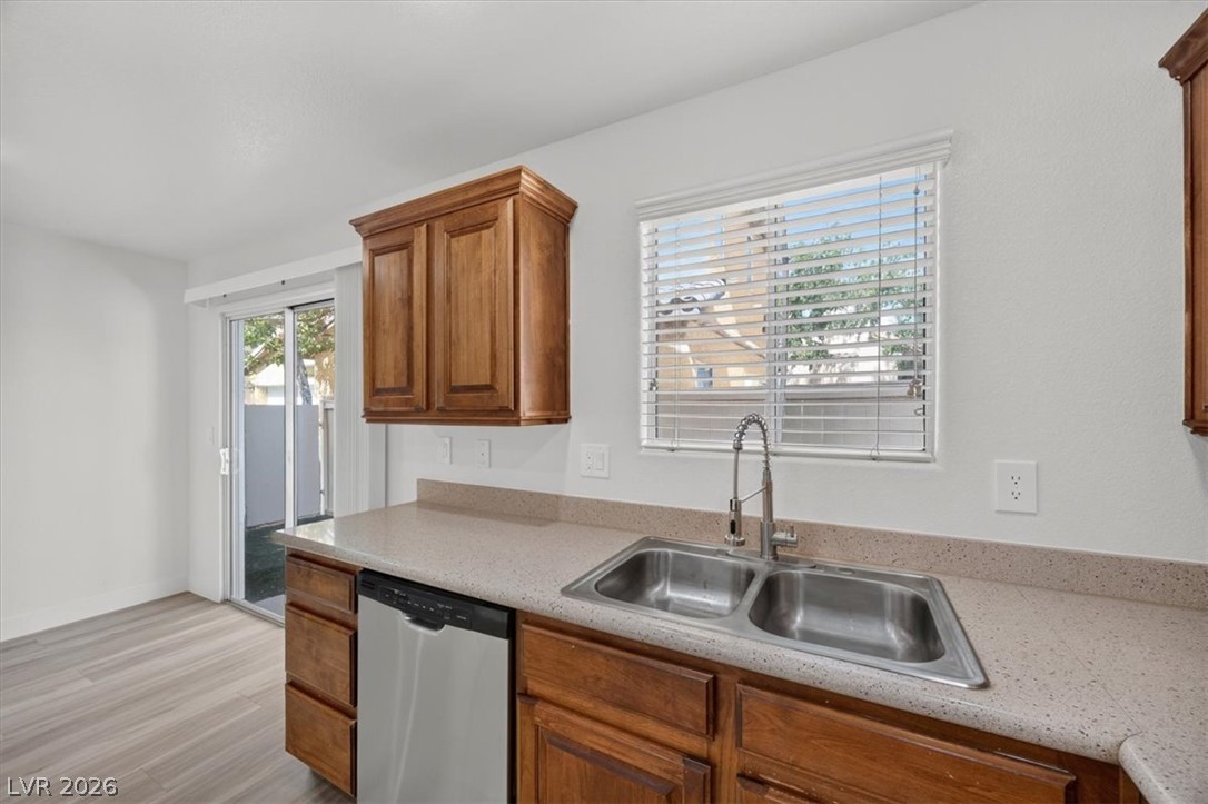 552 Albacate Street Henderson, NV 89015 - Photo 14 of 40 A well-appointed kitchen offers ample counter space, a double sink, and direct outdoor access.
