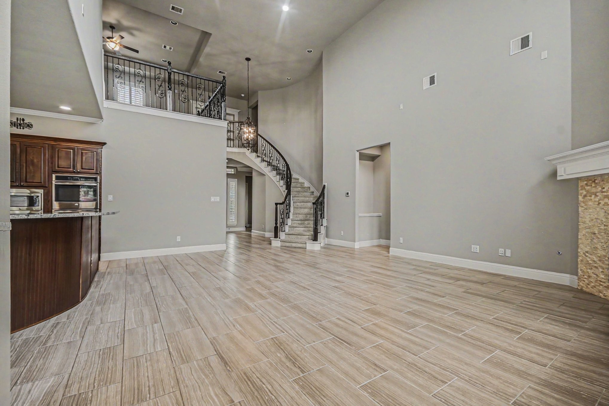 3310 Ralston Edge Lane Houston, TX 77059 - Photo 11 of 50 a view of empty room with wooden floor and fireplace