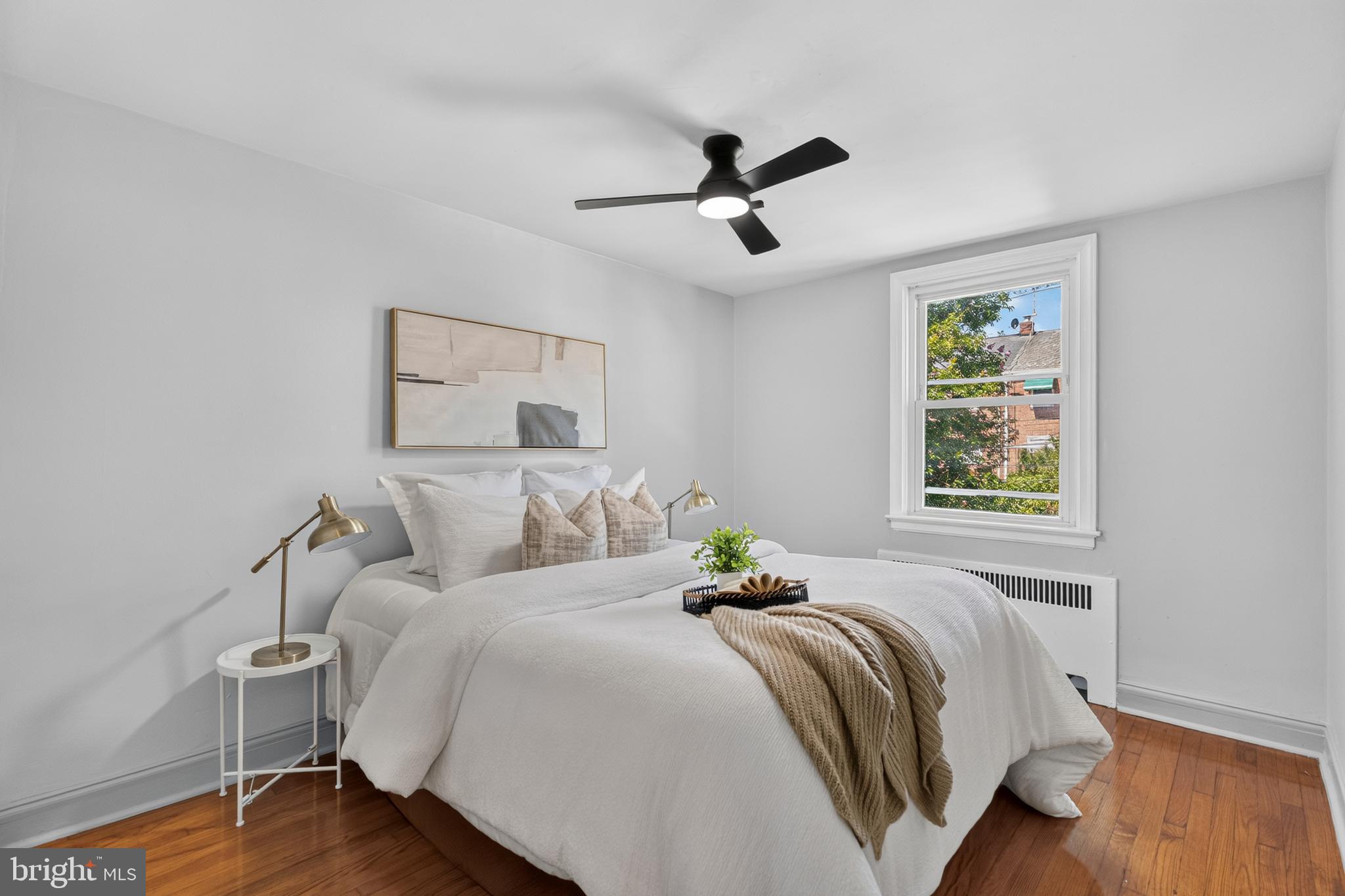 3906 Yolando Road Baltimore, MD 21218 - Photo 14 of 30 a bedroom with a bed and wooden floor