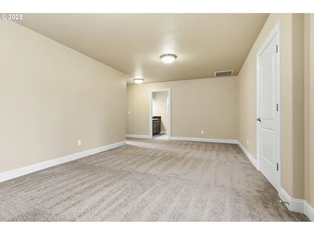 a view of an empty room and wooden floor
