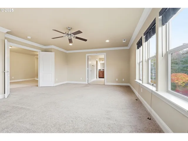 a view of a livingroom with a ceiling fan and window