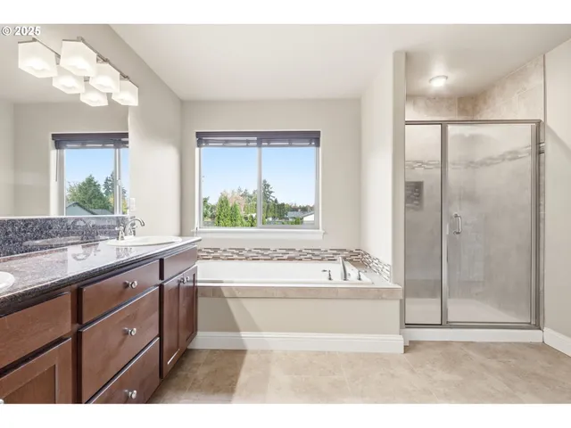 a bathroom with a tub sink and mirror