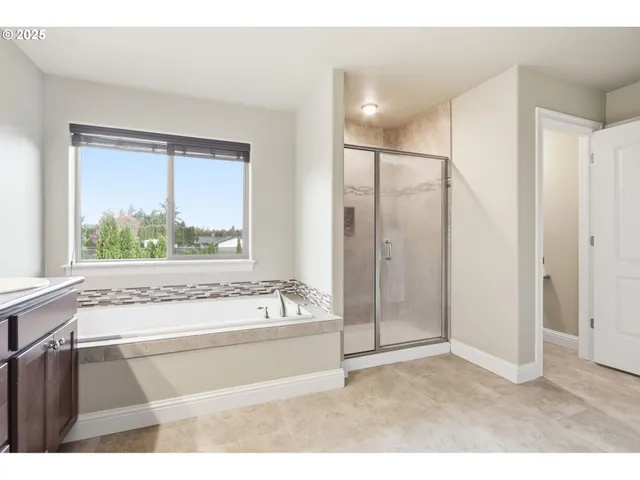 a bathroom with a bathtub and a shower