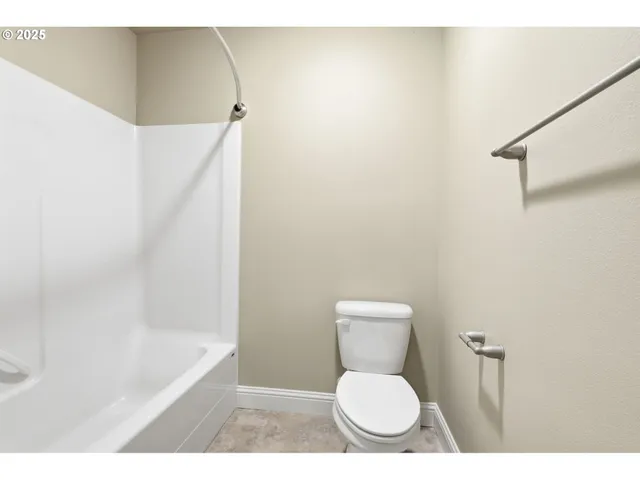 a bathroom with a toilet and a bathtub