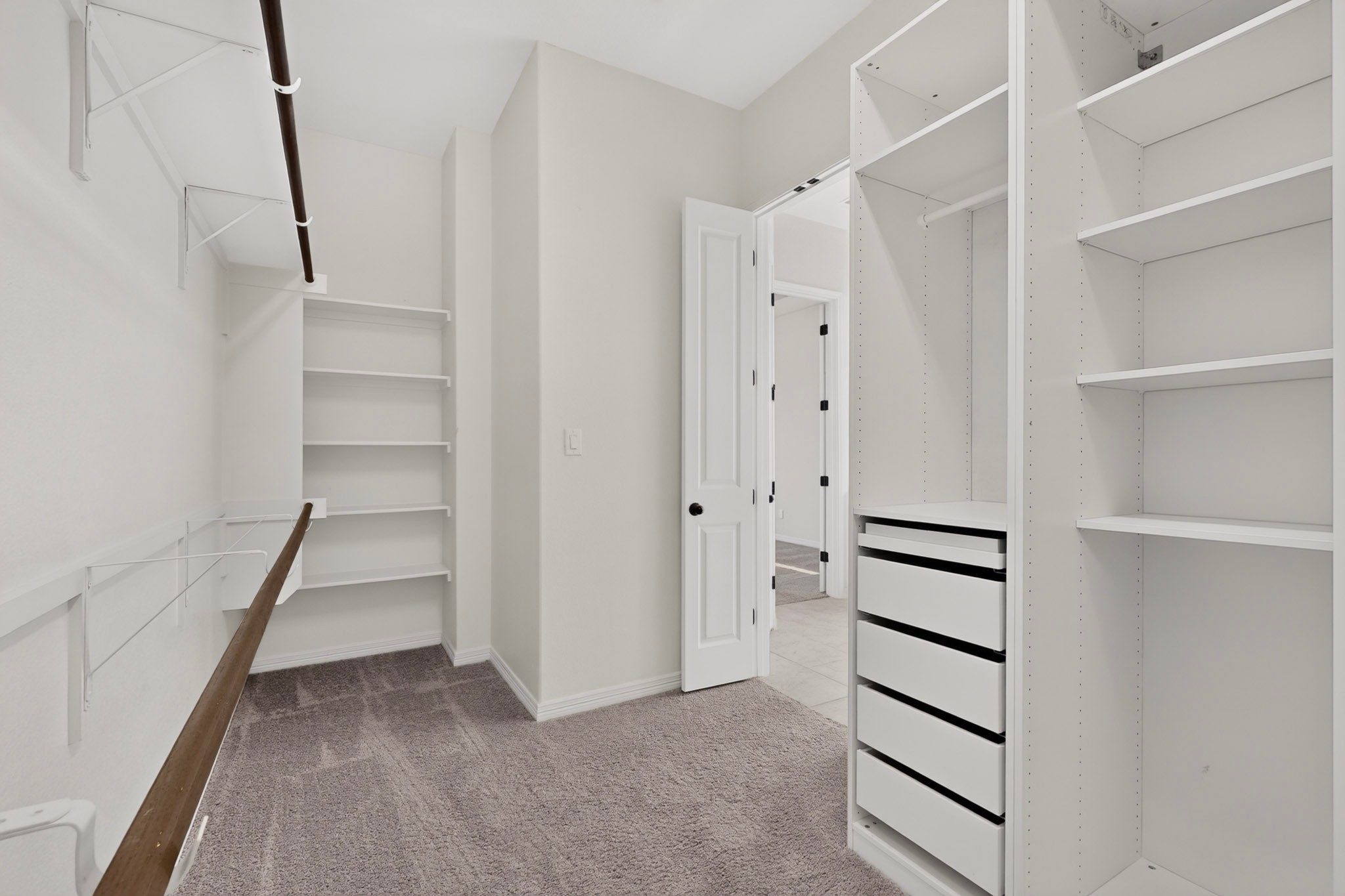 2433 La Mirada Street Leander, TX 78641 - Photo 11 of 25 Ample closet organization with generous shelving and hanging space in this practical walk-in.