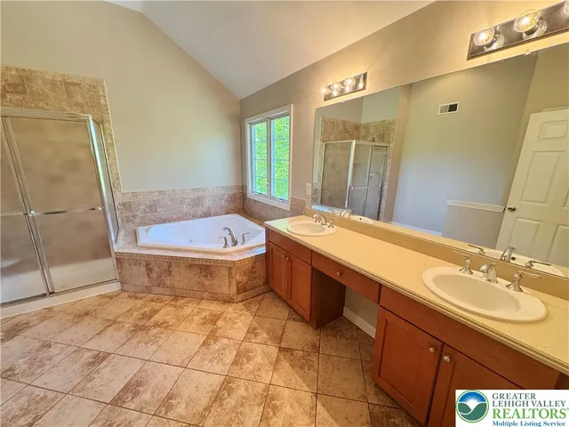 a bathroom with a sink a toilet a mirror and bathtub