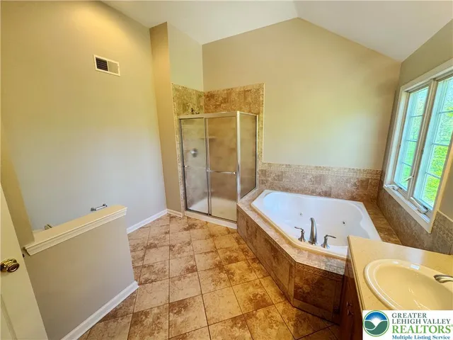 a bathroom with a tub a toilet and a sink