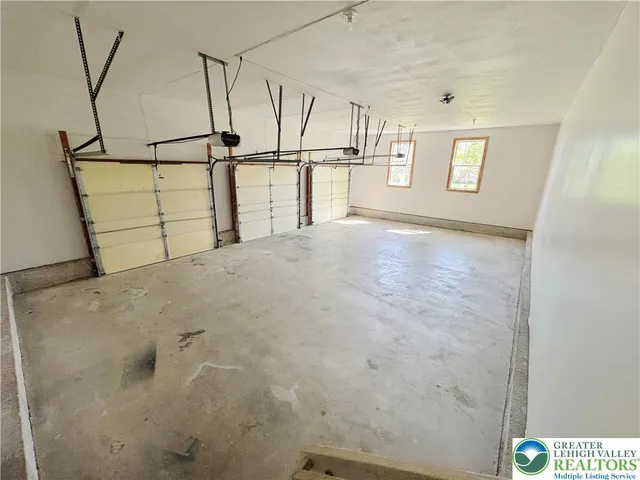 a view of a patio with table and chairs potted plants and large tree