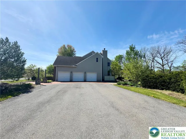 a view of a road with a house in the background