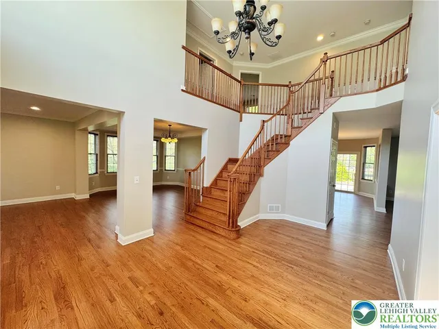a view of an entryway with wooden floor and stairs