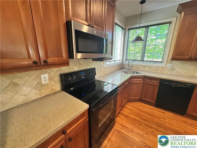 a kitchen with a sink and a stove top oven