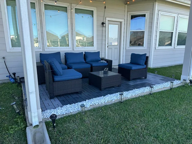a view of backyard with outdoor seating and green space