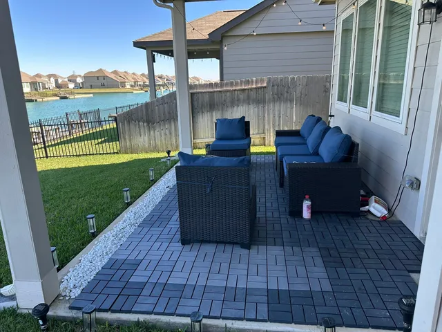 a view of a patio with lawn chairs and wooden floor