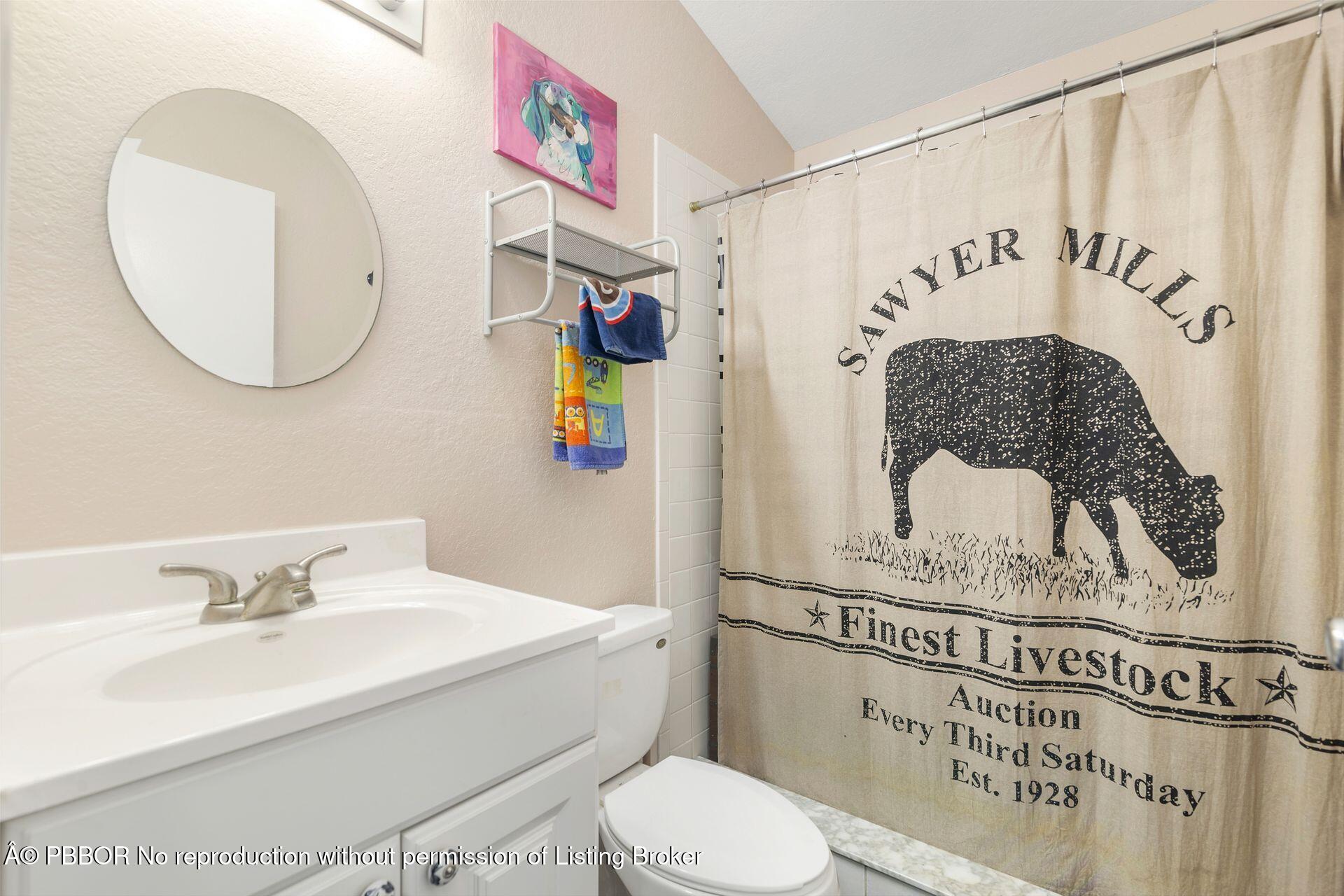 2770 E Road Loxahatchee, FL 33470 - Photo 38 of 51 a bathroom with a sink a mirror and a toilet