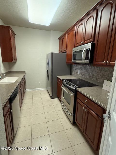 3868 Lexmark Lane, Unit 309 Rockledge, FL 32955 - Photo 11 of 39 a kitchen with stainless steel appliances granite countertop a refrigerator stove and sink