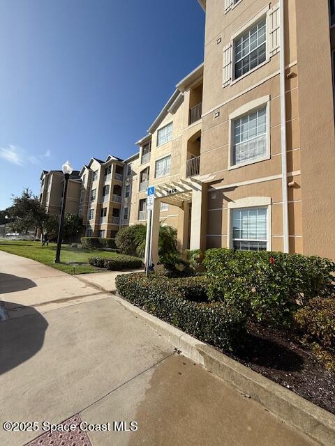 3868 Lexmark Lane, Unit 309 Rockledge, FL 32955 - Photo 30 of 40 a view of a building with a yard
