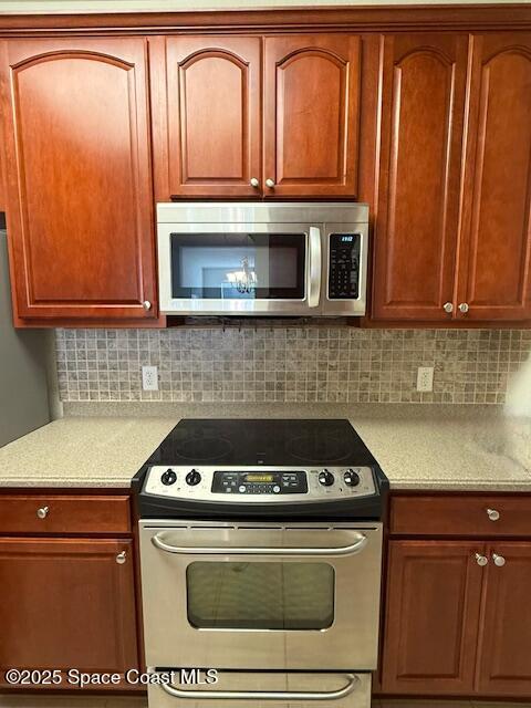 3868 Lexmark Lane, Unit 309 Rockledge, FL 32955 - Photo 7 of 39 a kitchen with granite countertop cabinets stove and oven
