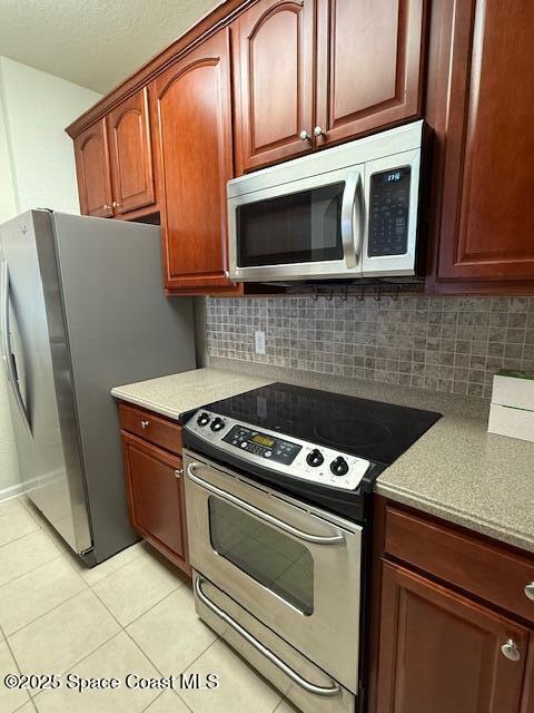 3868 Lexmark Lane, Unit 309 Rockledge, FL 32955 - Photo 10 of 39 a kitchen with stainless steel appliances granite countertop a stove microwave and refrigerator