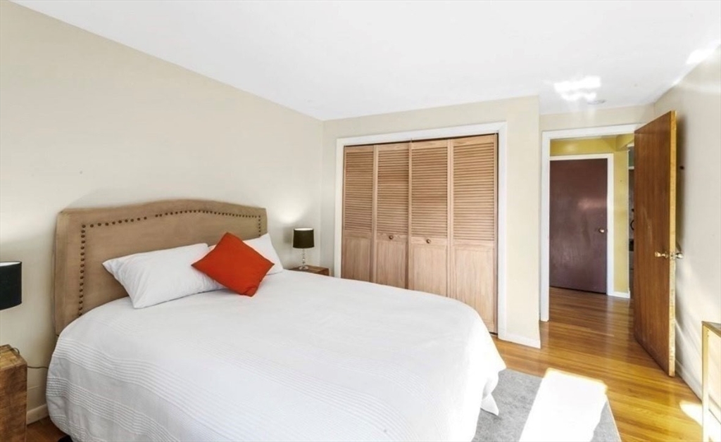 10 Coffey Street, Unit 22 Boston, MA 02122 - Photo 3 of 12 a bedroom with a large bed and a large window