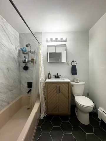 a bathroom with a toilet a sink and bathtub