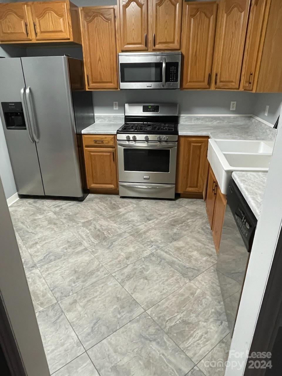616 Rustling Winds Drive York, SC 29745 - Photo 15 of 16 a kitchen with stainless steel appliances granite countertop a stove a sink and a microwave