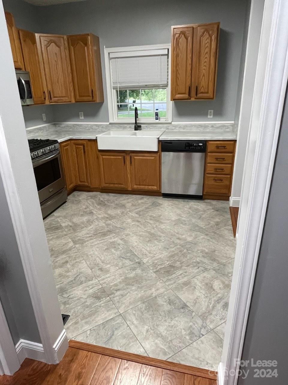 616 Rustling Winds Drive York, SC 29745 - Photo 16 of 16 a kitchen with granite countertop a sink and a stove