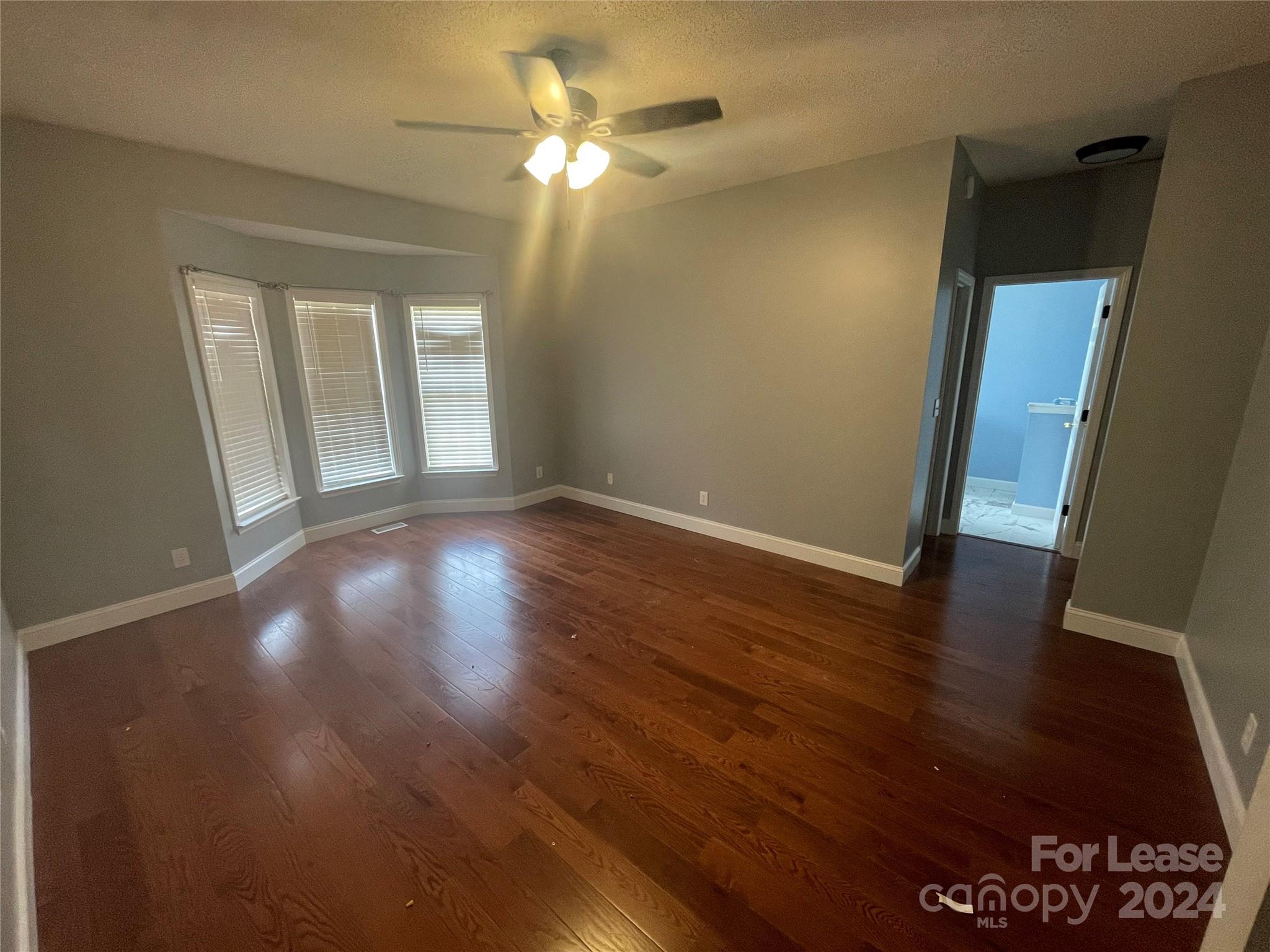 616 Rustling Winds Drive York, SC 29745 - Photo 7 of 16 wooden floor in an empty room with a window