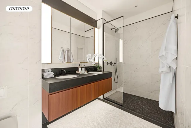 a bathroom with a sink a mirror and a shower