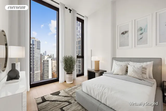 a bedroom with a large bed and a large window