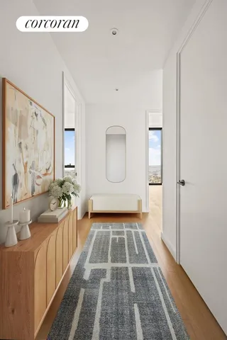 a view of a bedroom with wooden floor and windows