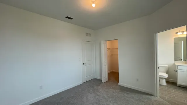 a view of room with a toilet and a walk in closet